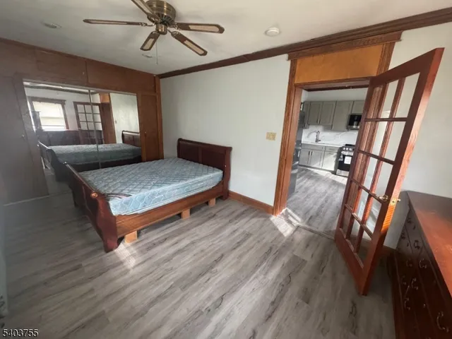 a living room with wooden floor and a window