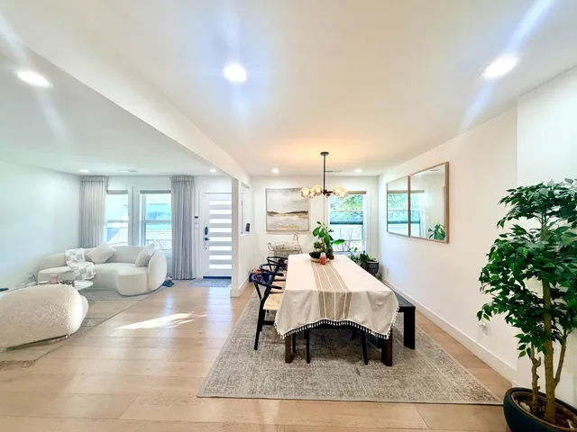 a living room with furniture potted plant and a chandelier