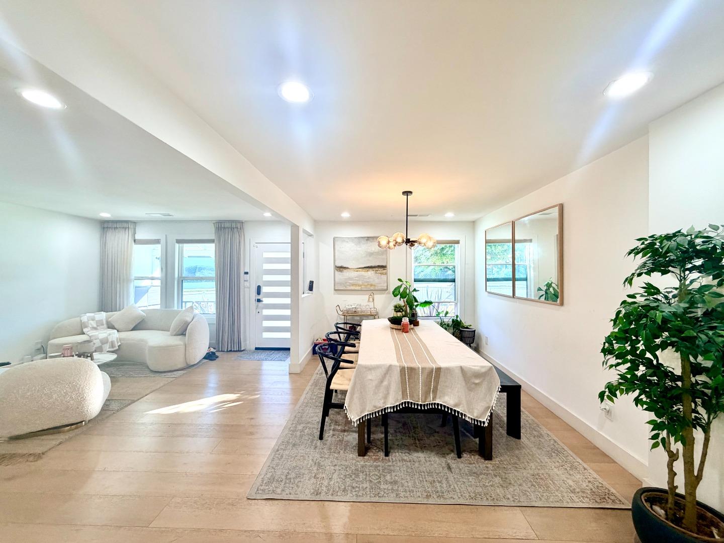 1215 North Bascom Avenue San Jose, CA 95128 - Photo 12 of 15 a living room with furniture potted plant and a chandelier