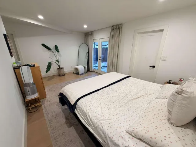 a bedroom with bed and window