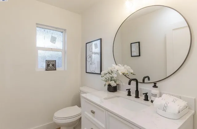 a bathroom with a toilet sink and mirror