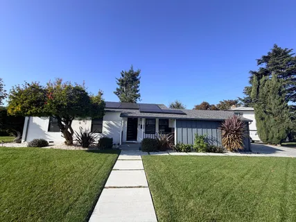 a front view of a house with a yard table and chairs