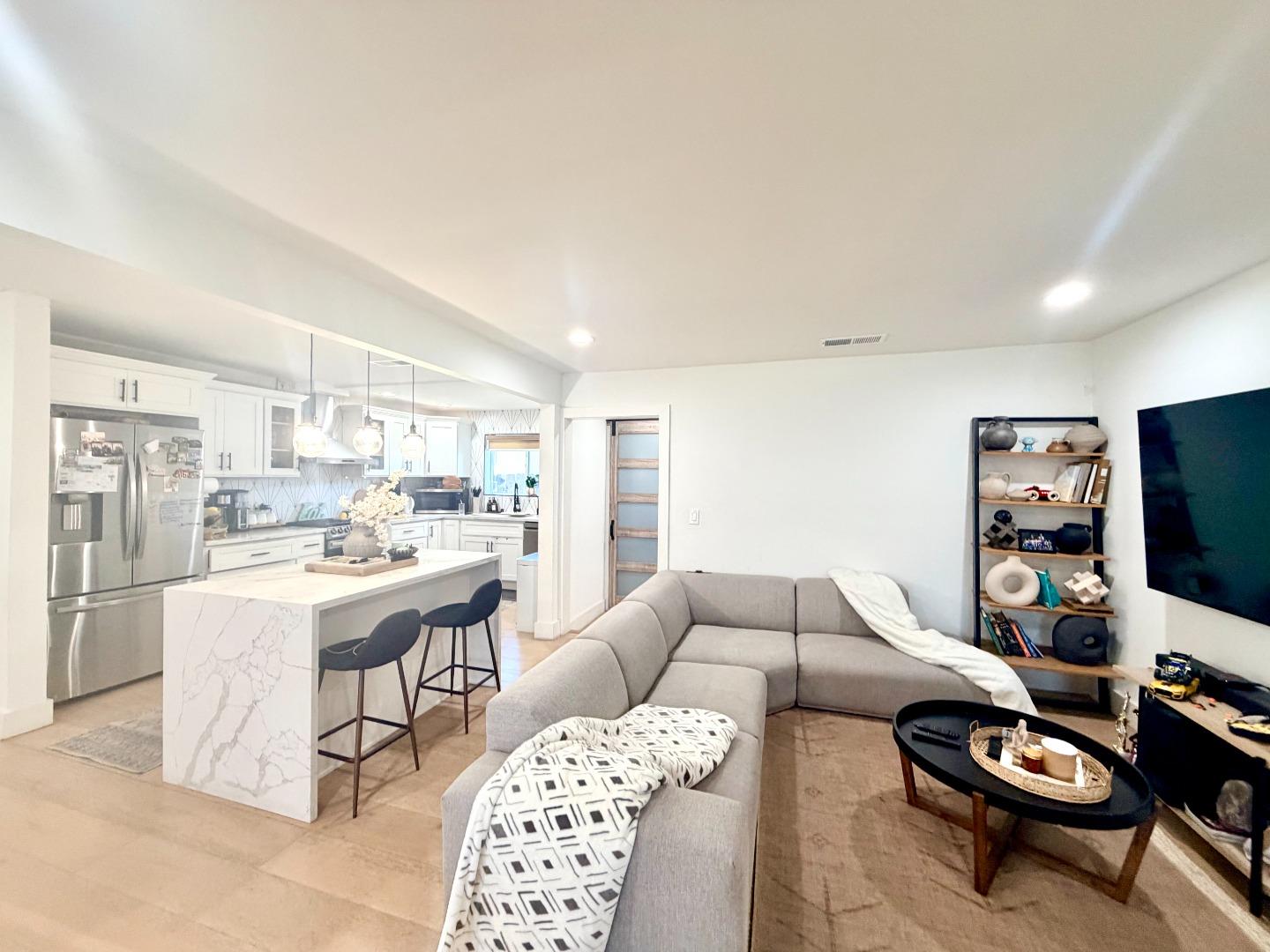 1215 North Bascom Avenue San Jose, CA 95128 - Photo 9 of 15 a living room with furniture and a flat screen tv