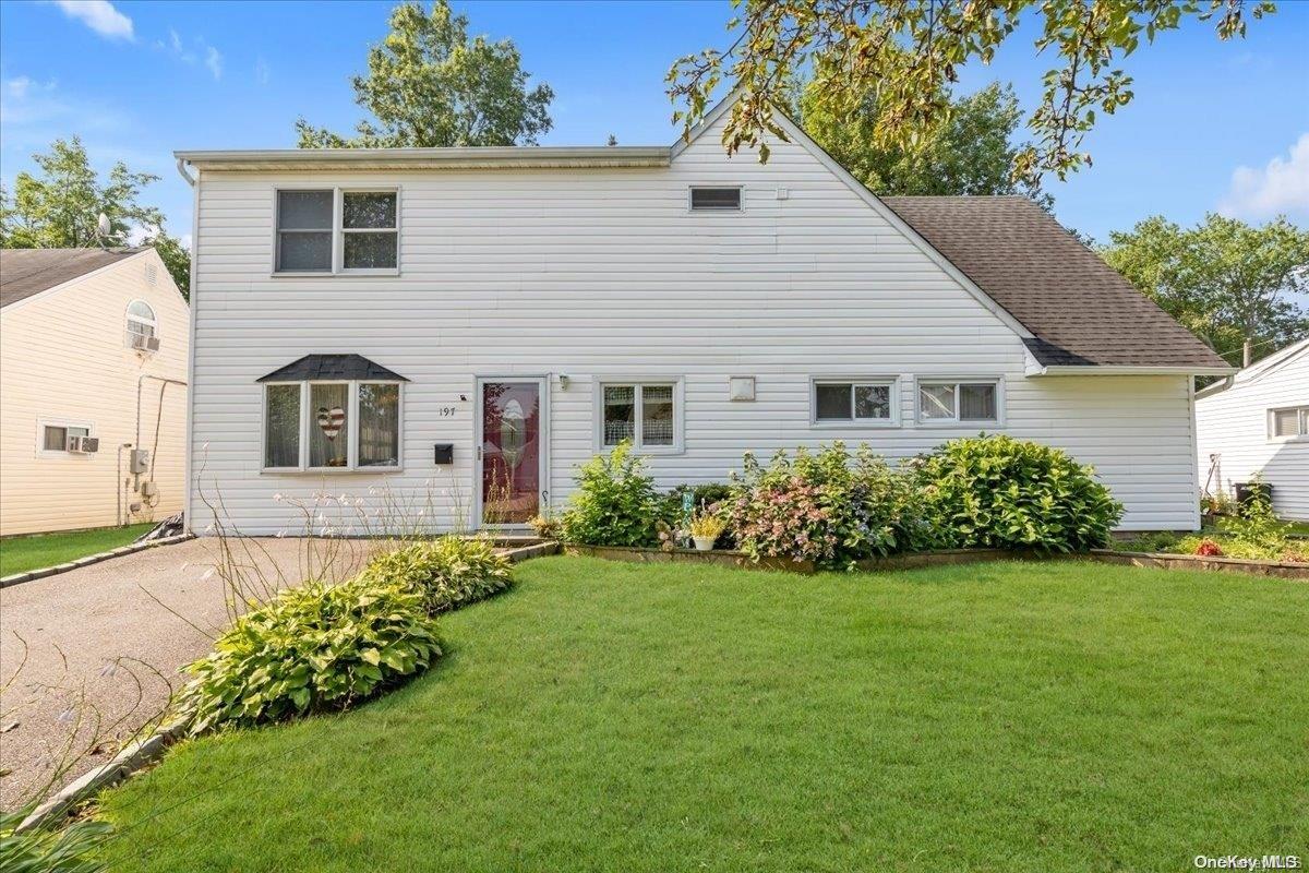 a front view of a house with a garden