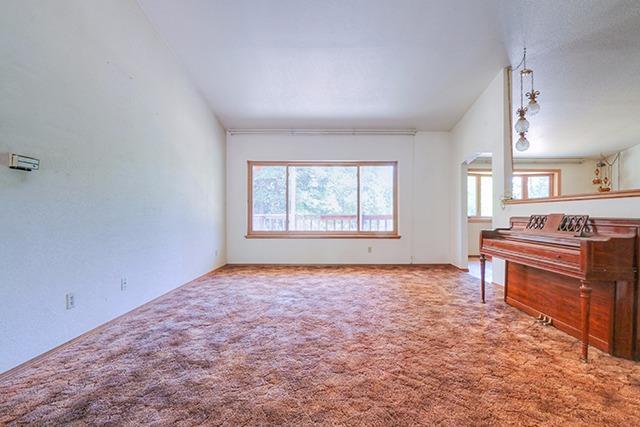 494 Onion Mountain Road Wilderville, OR 97543 - Photo 4 of 23 an empty room with a window