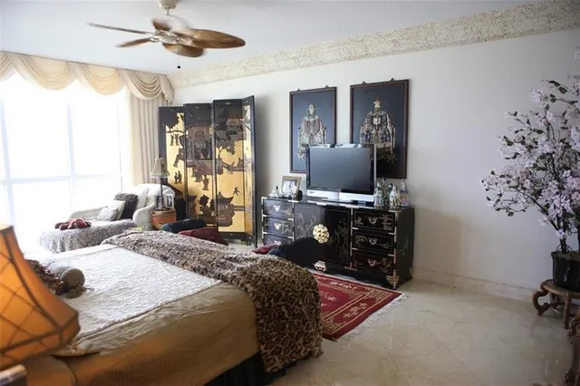 a bedroom with a bed and a painting on the wall