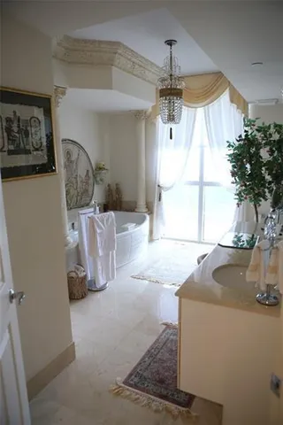 a bathroom with a double vanity sink toilet and shower