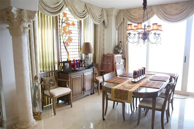 a kitchen with granite countertop a table chairs stove and cabinets