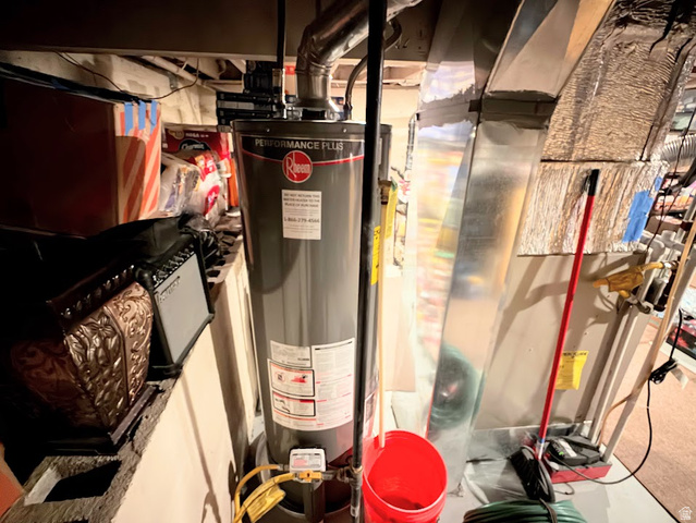737 Wasatch Street Midvale, UT 84047 - Photo 19 of 29 Rheem Performance Plus water heater installation with exposed ductwork and structural elements