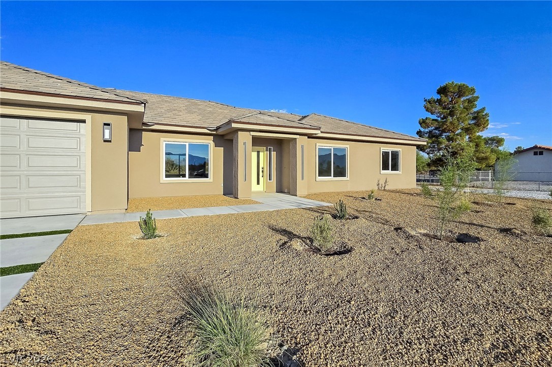 1120 West Gamebird Road Pahrump, NV 89048 - Photo 6 of 36 Ranch-style house with stucco siding and a garage