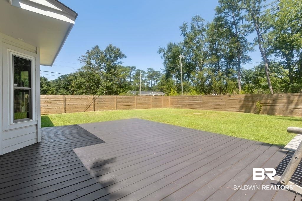601 East Gate Circle Foley, AL 36535 - Photo 4 of 26 Wooden terrace featuring a lawn