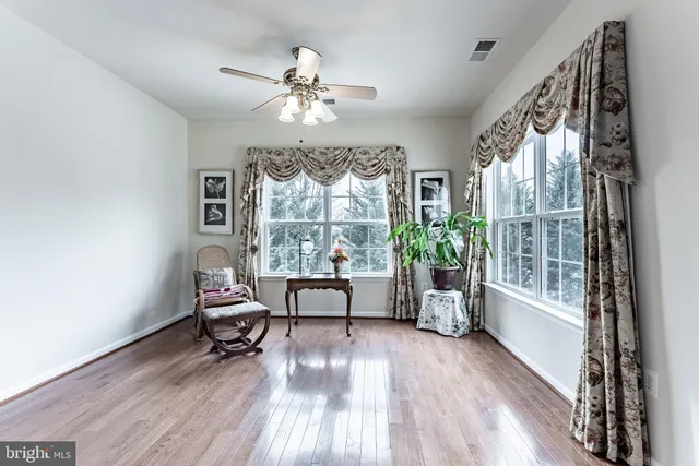 a view of a livingroom with furniture window and wooden floor