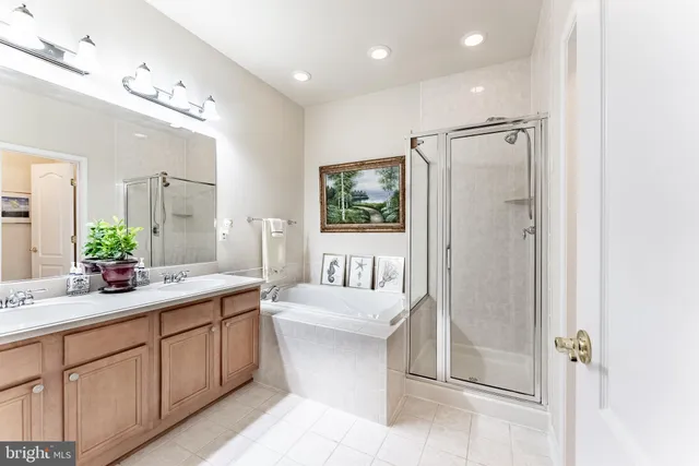a bathroom with a double vanity sink mirror and shower