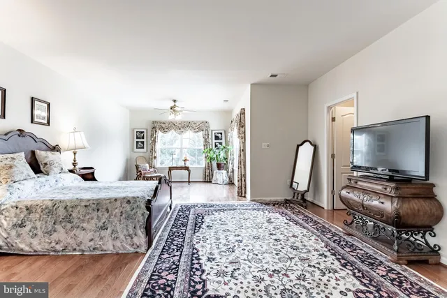 a bedroom with furniture and a flat screen tv