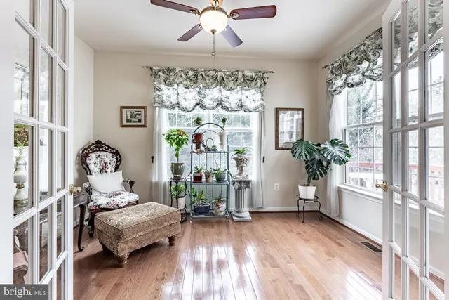 a bedroom with furniture and a large window