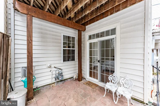 a view of a porch with a table and chairs and potted plants
