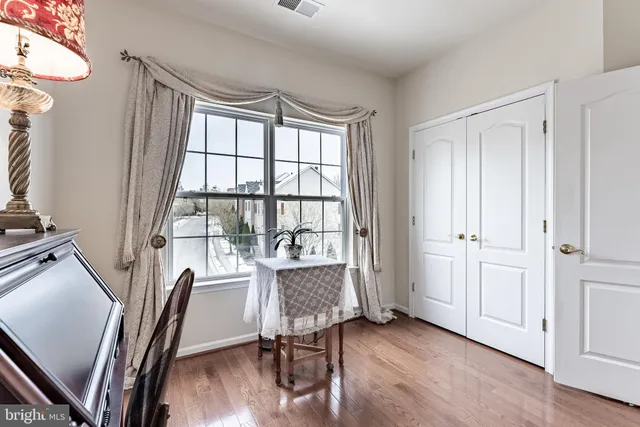a view of a workspace with furniture and a window