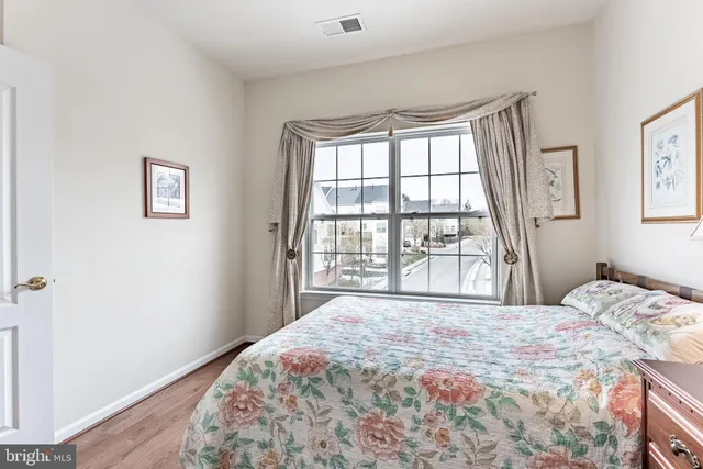 a bedroom with a large bed and a large window