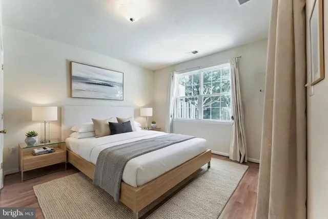 a bedroom with a bed lamp and a window