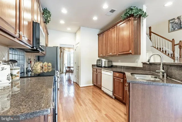 a kitchen with sink cabinets and wooden floor