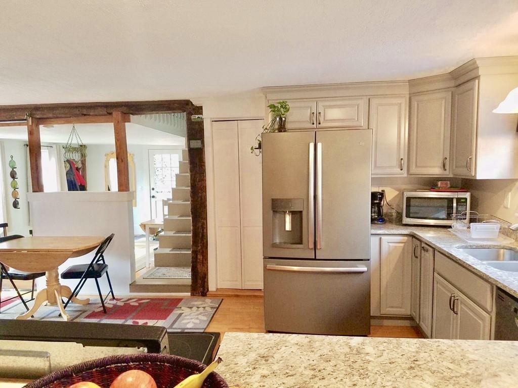 47 Chapin Road Hampden, MA 01036 - Photo 7 of 30 a kitchen with stainless steel appliances kitchen island granite countertop a refrigerator and a stove top oven