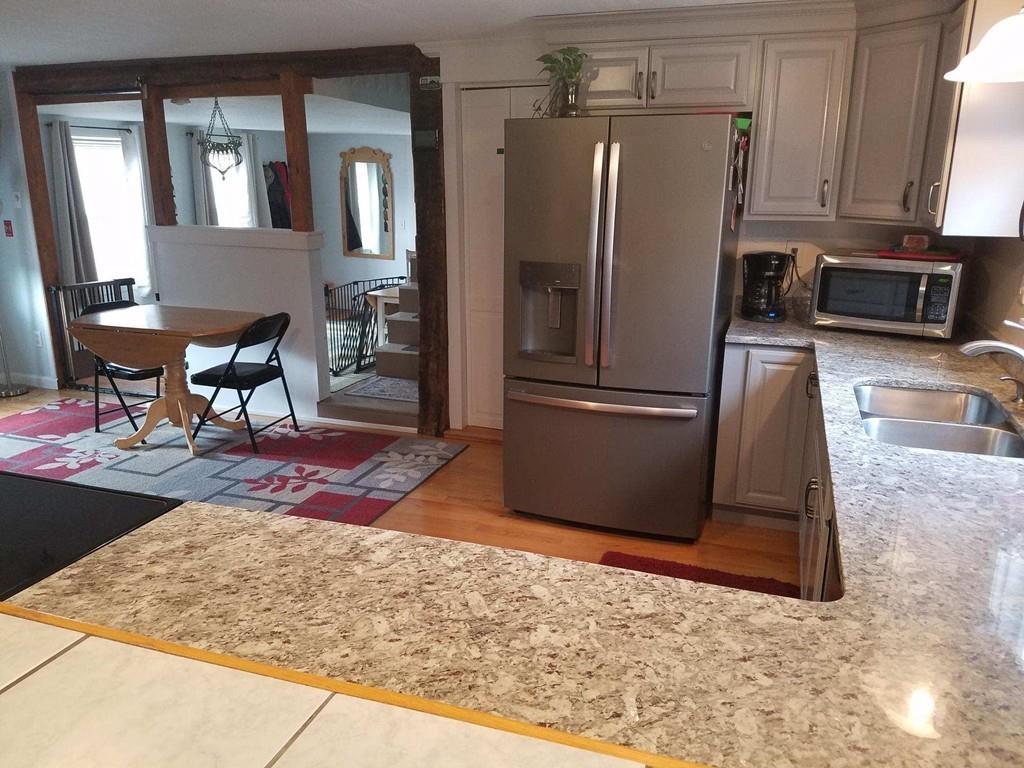 47 Chapin Road Hampden, MA 01036 - Photo 8 of 30 a kitchen with stainless steel appliances granite countertop a refrigerator a stove and a sink