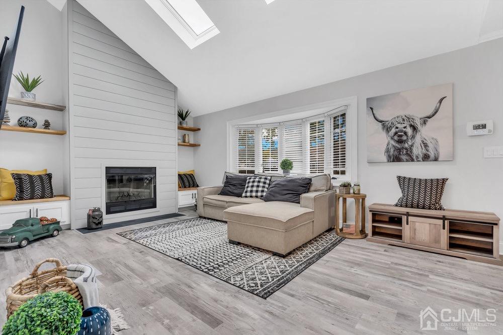 17 Whitney Drive Middlesex, NJ 08846 - Photo 2 of 18 a living room with furniture a fireplace and a window