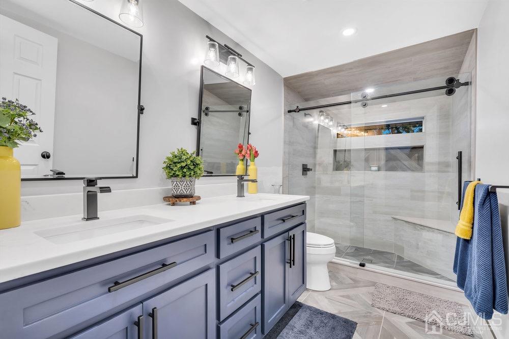 17 Whitney Drive Middlesex, NJ 08846 - Photo 12 of 18 a bathroom with a sink a toilet and shower