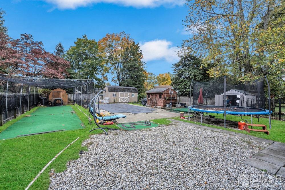 17 Whitney Drive Middlesex, NJ 08846 - Photo 13 of 18 a view of a yard with a bench and trees