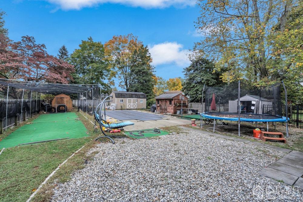 17 Whitney Drive Middlesex, NJ 08846 - Photo 16 of 18 a backyard of a house with table and chairs