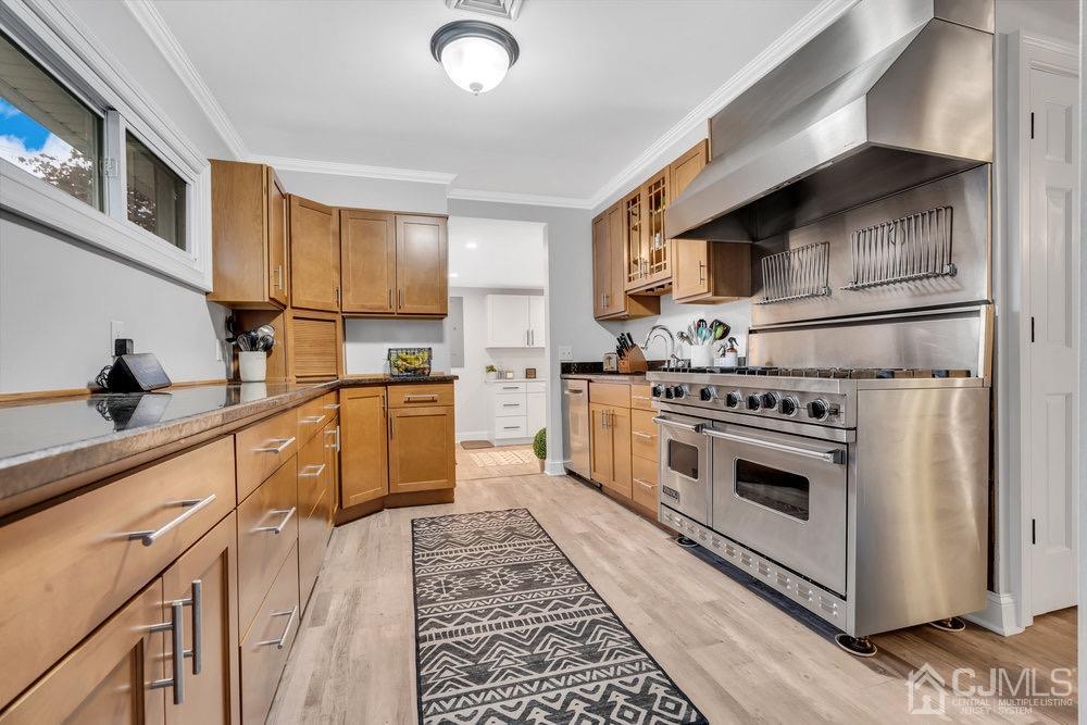 17 Whitney Drive Middlesex, NJ 08846 - Photo 3 of 18 a kitchen with a stove top oven and cabinets