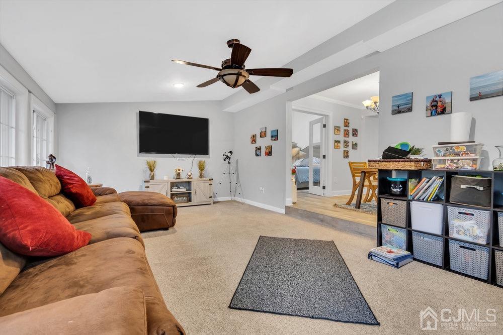 17 Whitney Drive Middlesex, NJ 08846 - Photo 10 of 18 a living room with furniture and a flat screen tv