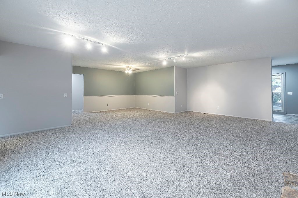 10808 Priem Road Strongsville, OH 44149 - Photo 6 of 26 Carpeted spare room with a textured ceiling and track lighting