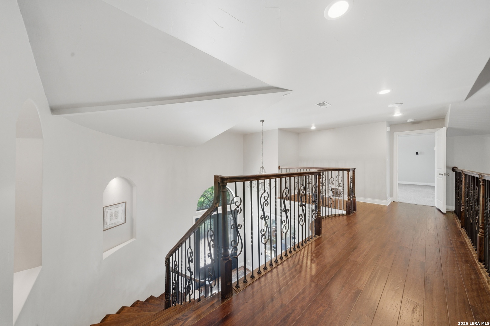 10042 Rafter S Trail Helotes, TX 78023 - Photo 32 of 69 a view of a hallway with wooden floor and stairs