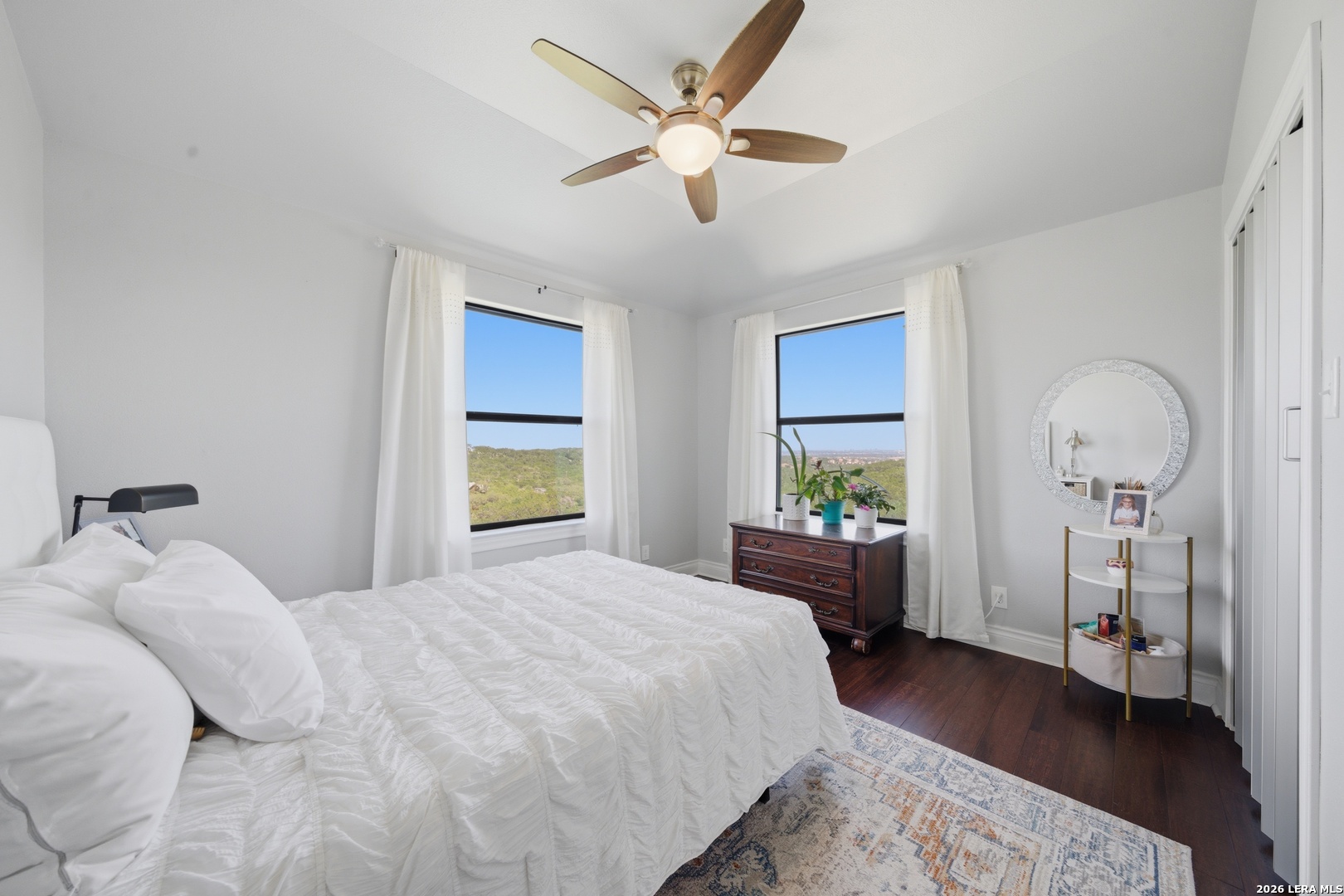 10042 Rafter S Trail Helotes, TX 78023 - Photo 41 of 69 a bedroom with a large bed and a chandelier