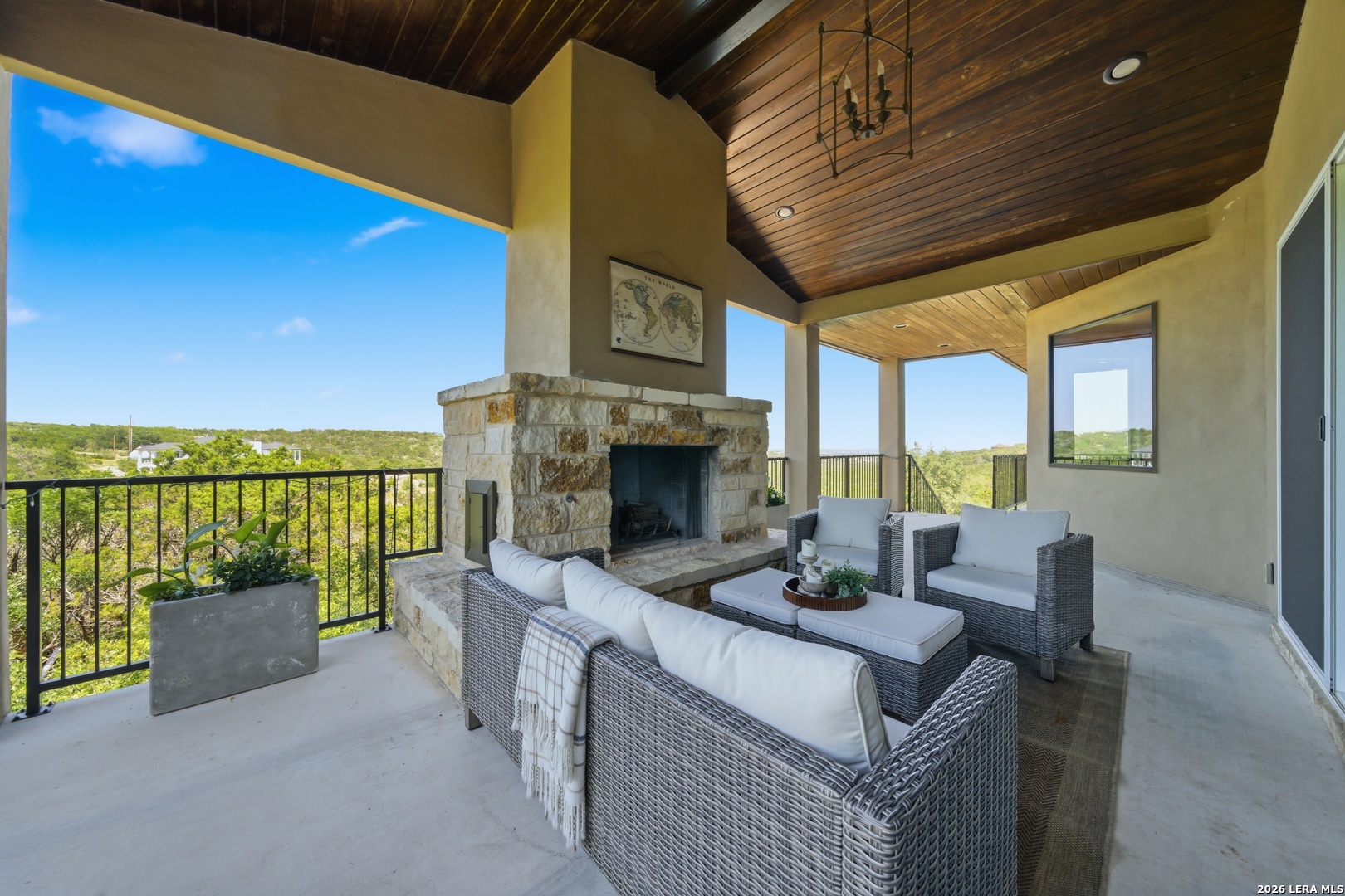 10042 Rafter S Trail Helotes, TX 78023 - Photo 42 of 69 a view of a patio with couches table and chairs with wooden floor and fence