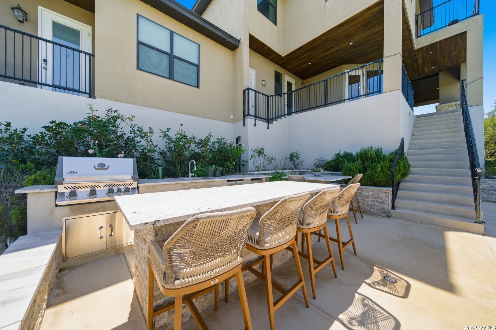 10042 Rafter S Trail Helotes, TX 78023 - Photo 44 of 69 a roof deck with table and chairs and potted plants