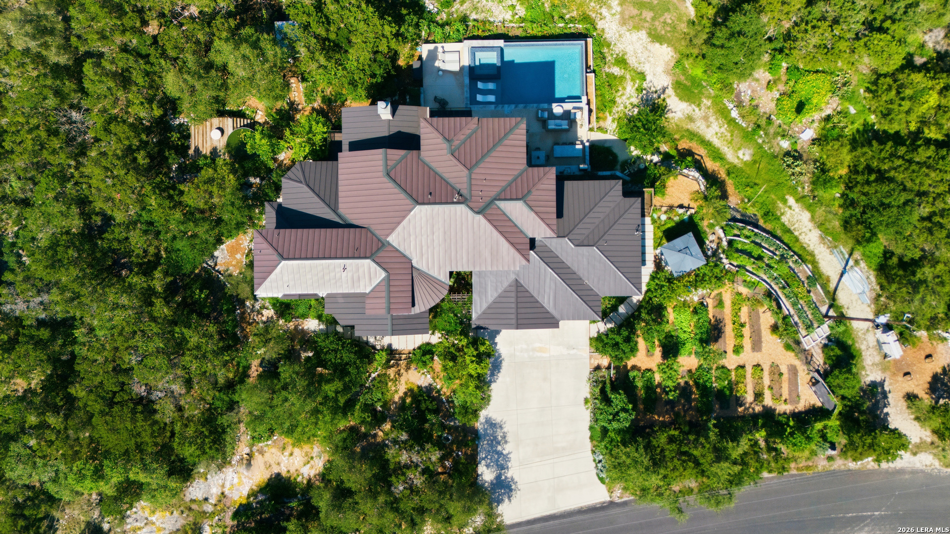 10042 Rafter S Trail Helotes, TX 78023 - Photo 50 of 69 an aerial view of a house with a yard and garden