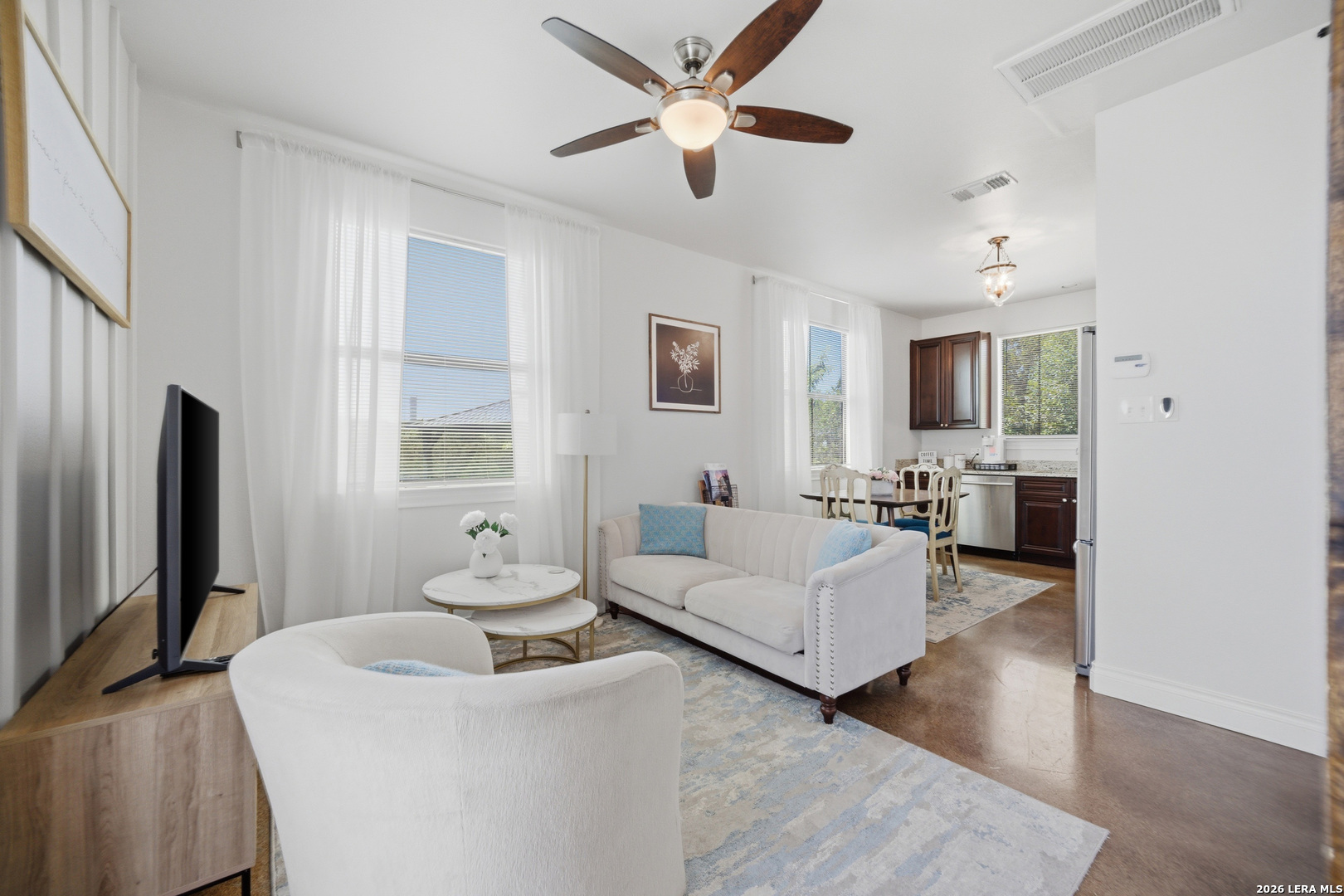 10042 Rafter S Trail Helotes, TX 78023 - Photo 59 of 69 a living room with furniture a large window and a flat screen tv
