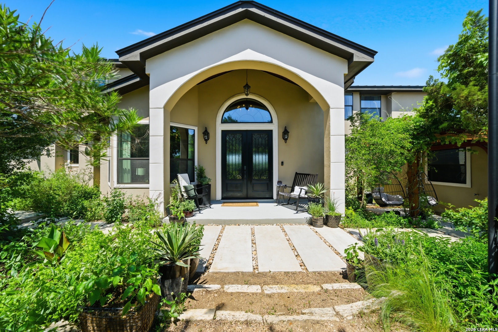 10042 Rafter S Trail Helotes, TX 78023 - Photo 6 of 69 a front view of a house with a garden