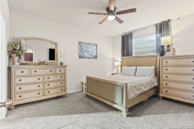 a spacious bedroom with a bed and a dresser