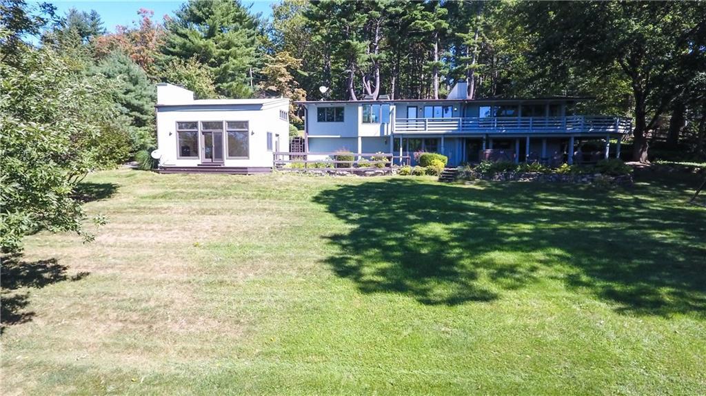 105 Stonecrest Road Ridgefield, CT 06877 - Photo 1 of 1 a front view of a house with a yard