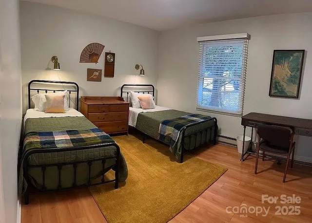 a bedroom with bed and a window