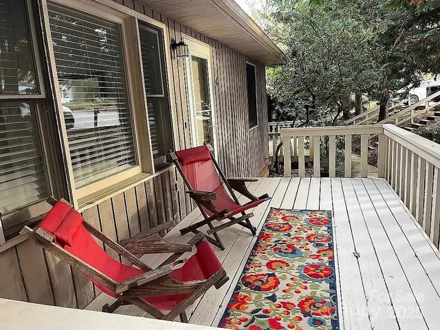 a view of balcony with wooden floor and outdoor seating