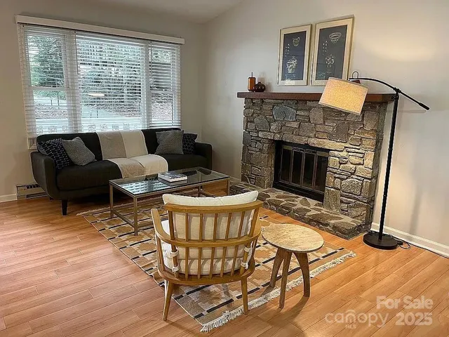 a living room with furniture and a fireplace