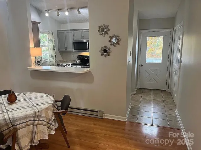 a view of a kitchen with furniture and wooden floor