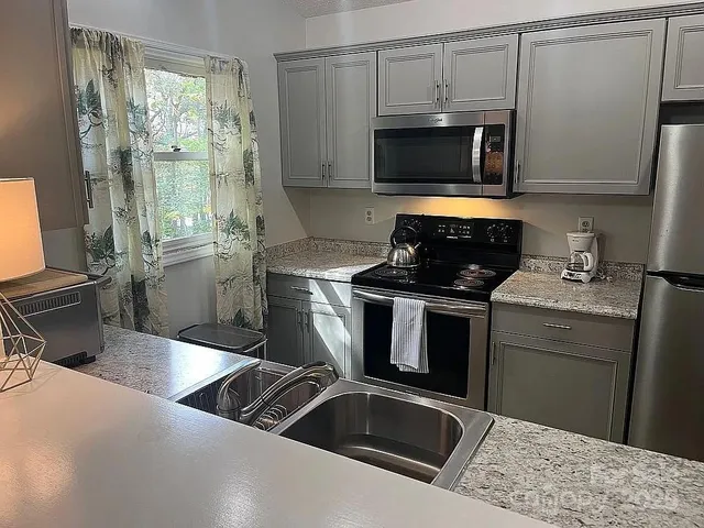 a kitchen with a stove microwave and sink