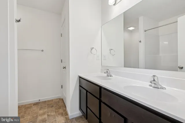 a bathroom with a sink double vanity and a mirror