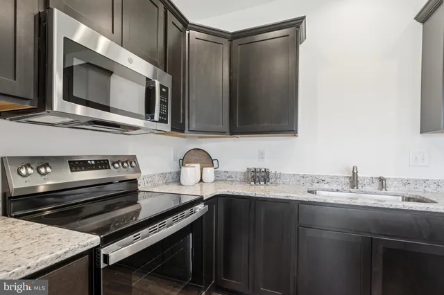 a kitchen with a sink stove and microwave