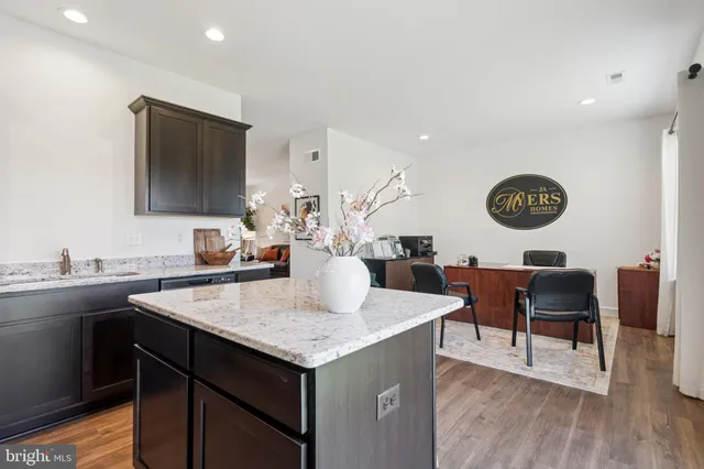 a view of a kitchen area with furniture and wooden floor